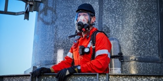 Firefighter in SCBA encapsulating suit for hazardous waste operations
