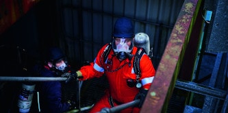 Firefighter wearing SCBA escape only respirator
