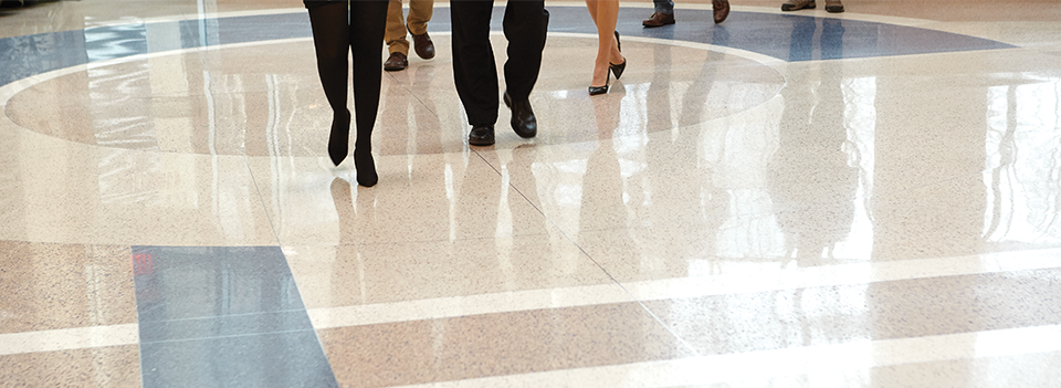 Image of people moving across gleaming tiled floors