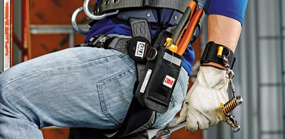 Image of worker wearing a wristband anchor attached to a wrench to prevent falling tools
