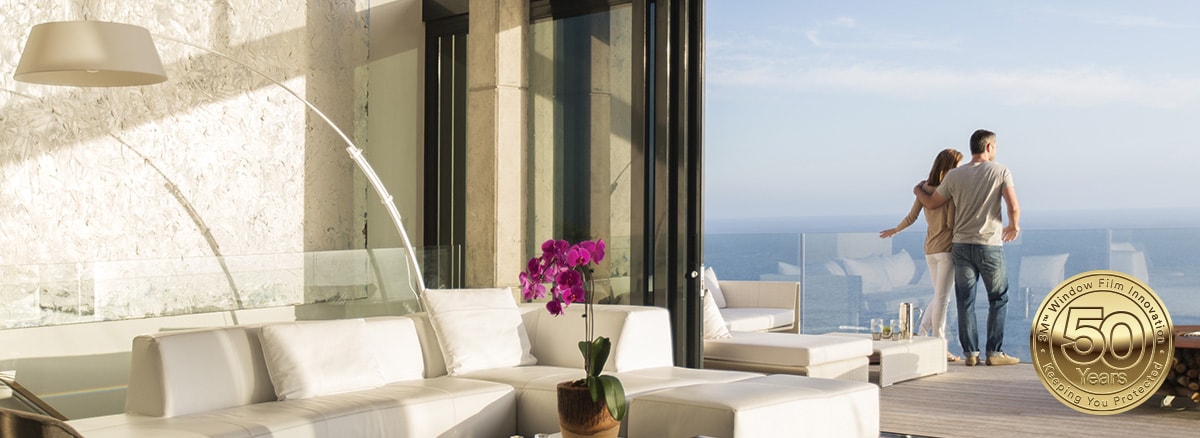 Couple overlooking at a glass terrace with household window tint
