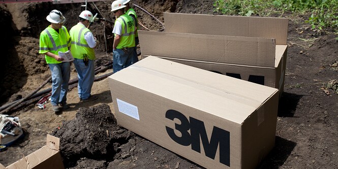 worker on jobsite with 3M box of product
