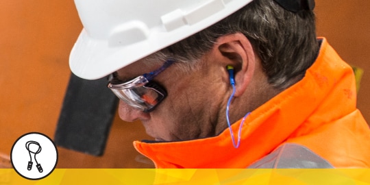Worker wearing hardhat and 3M essential hearing protection solution
