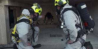 Firefighters in air supplied respirator for environmental remediation work
