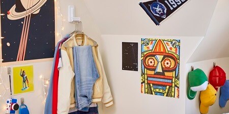 Apply Command folding clothes hanger in the corner of a bedroom
