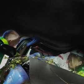 A rescue worker reaching out to a female victim