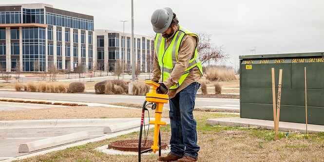 Worker on construction project wearing safety gear.
