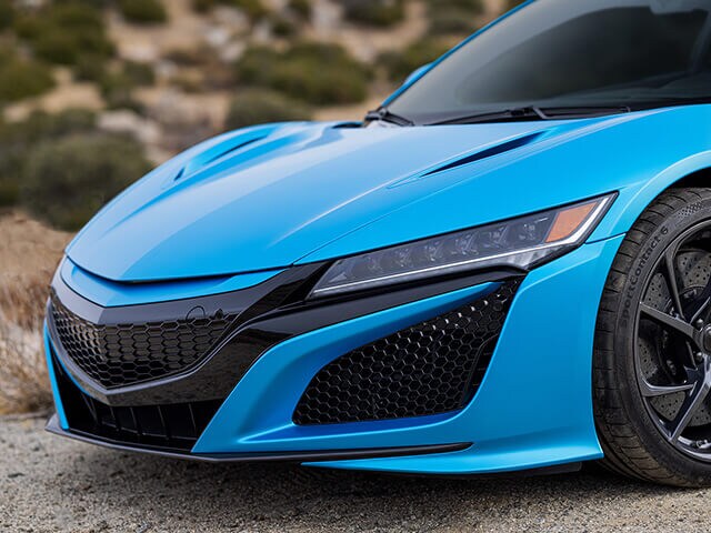 Close up of sports car front hood area with ocean shimmer blue colour wrap film