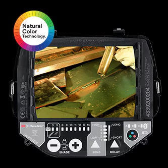 welder wearing 3M speedlgas welding helmet taping head
