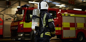 Firefighter in emergency breathing apparatus ready for response and rescue
