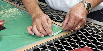 A man is  applying green colored composite bonding 
