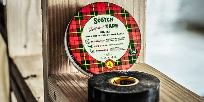 A vintage Scotch Super 33 electrical tape tin and tape
