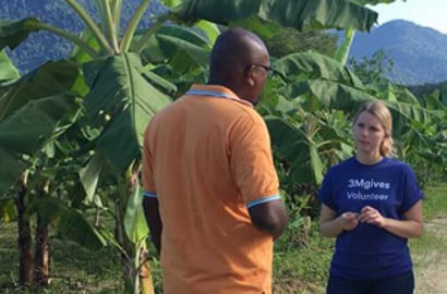 A man and a woman talking to each other in a field
