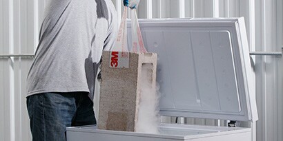 Use tape to pull a cinder block out of a freezer, showing it can be used in extreme conditions. 
