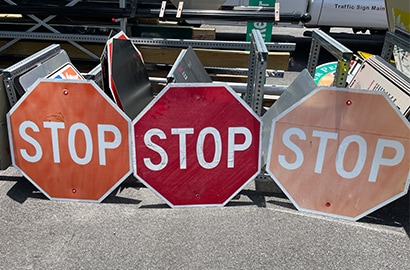 Stop sign comparison photo with three different competitve reflective sheeting products