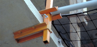 Image of debris safety net system attached to poured concrete floor
